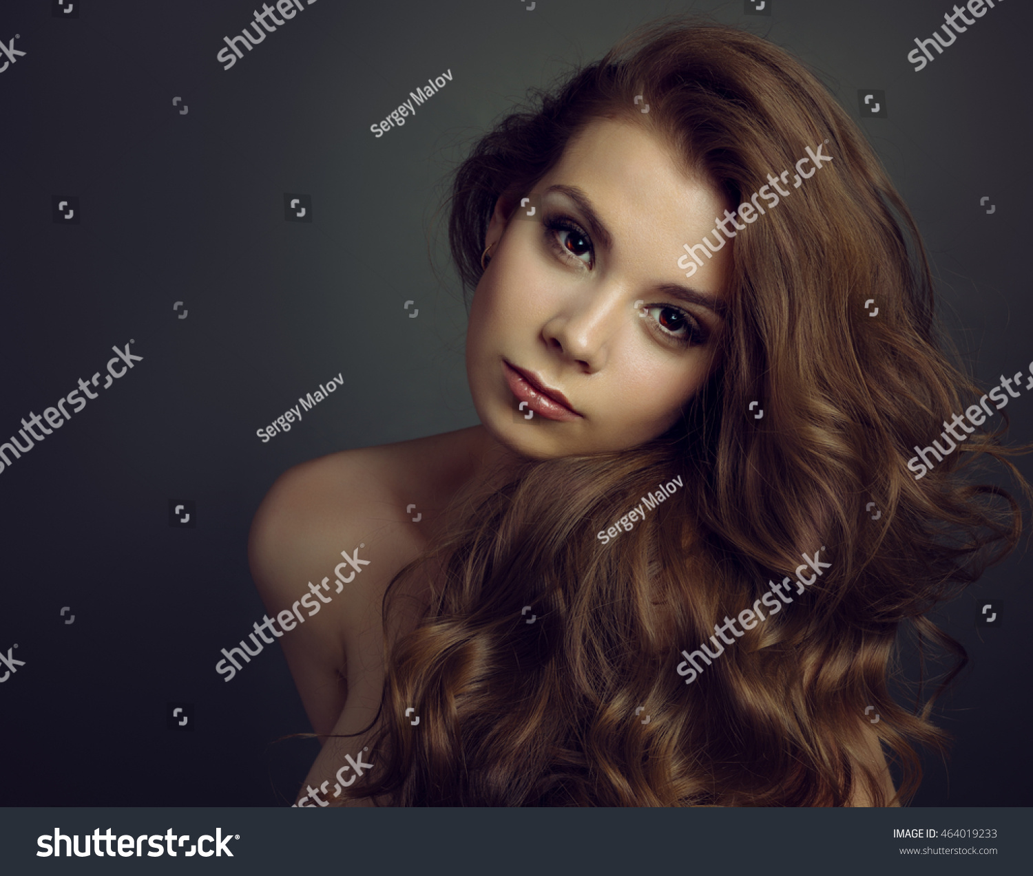 Portrait of a young beautiful brunette girl with long  hair #464019233