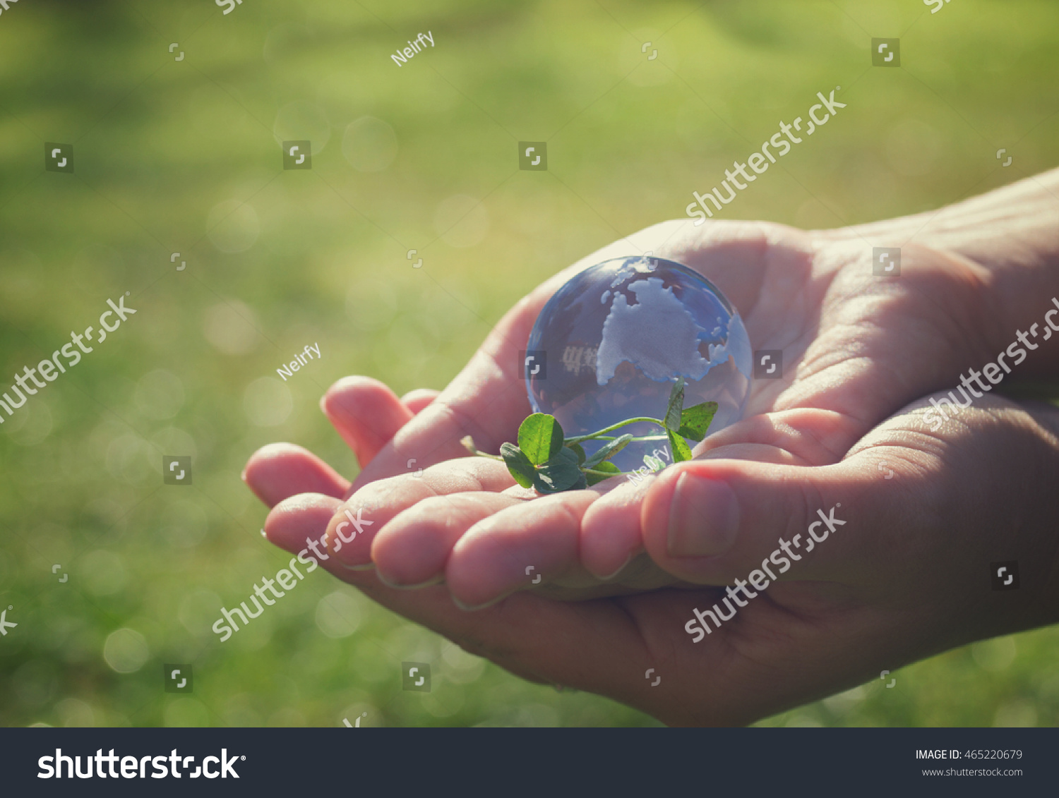 Two hands holding glass globe outdoor, concept for environment protection, retro toned #465220679