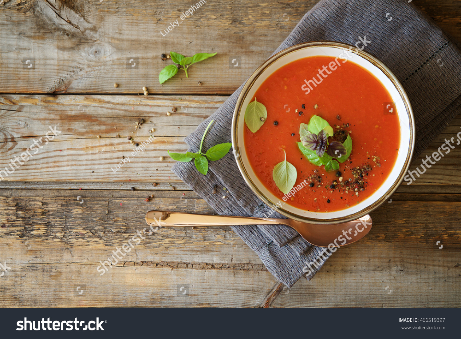 Tomato soup on wooden table, top view #466519397