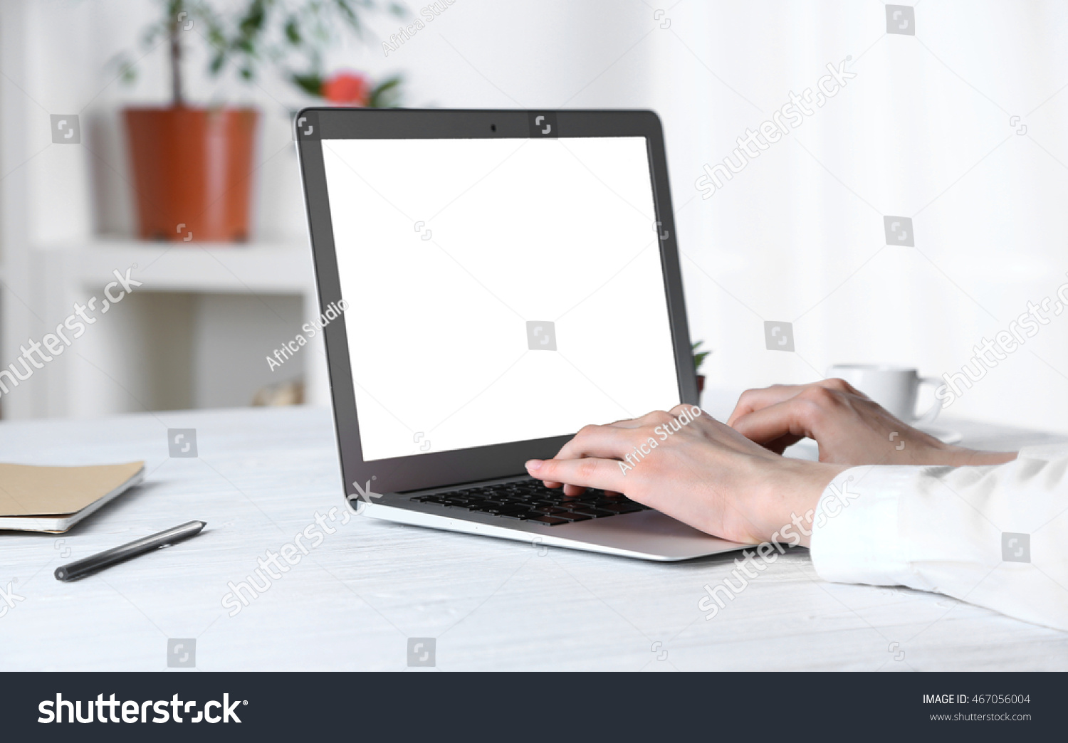 Businessman working on laptop indoors #467056004