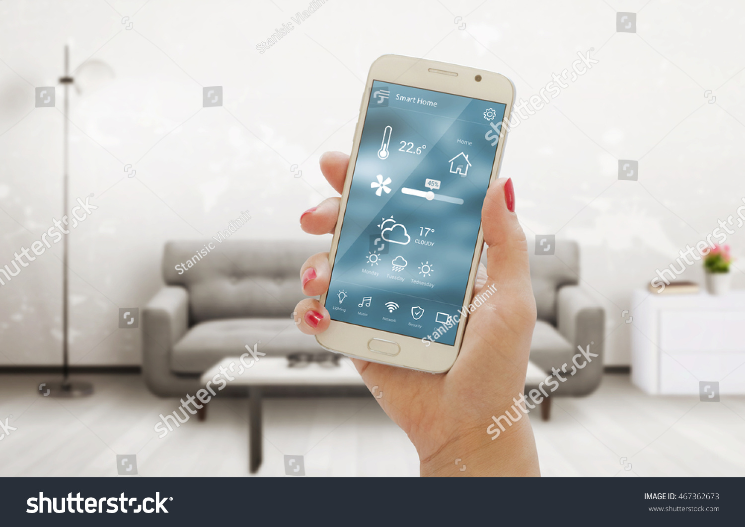 Home temperature, safety and environment control on mobile app. Smart phone in woman hand. Living room in background. #467362673