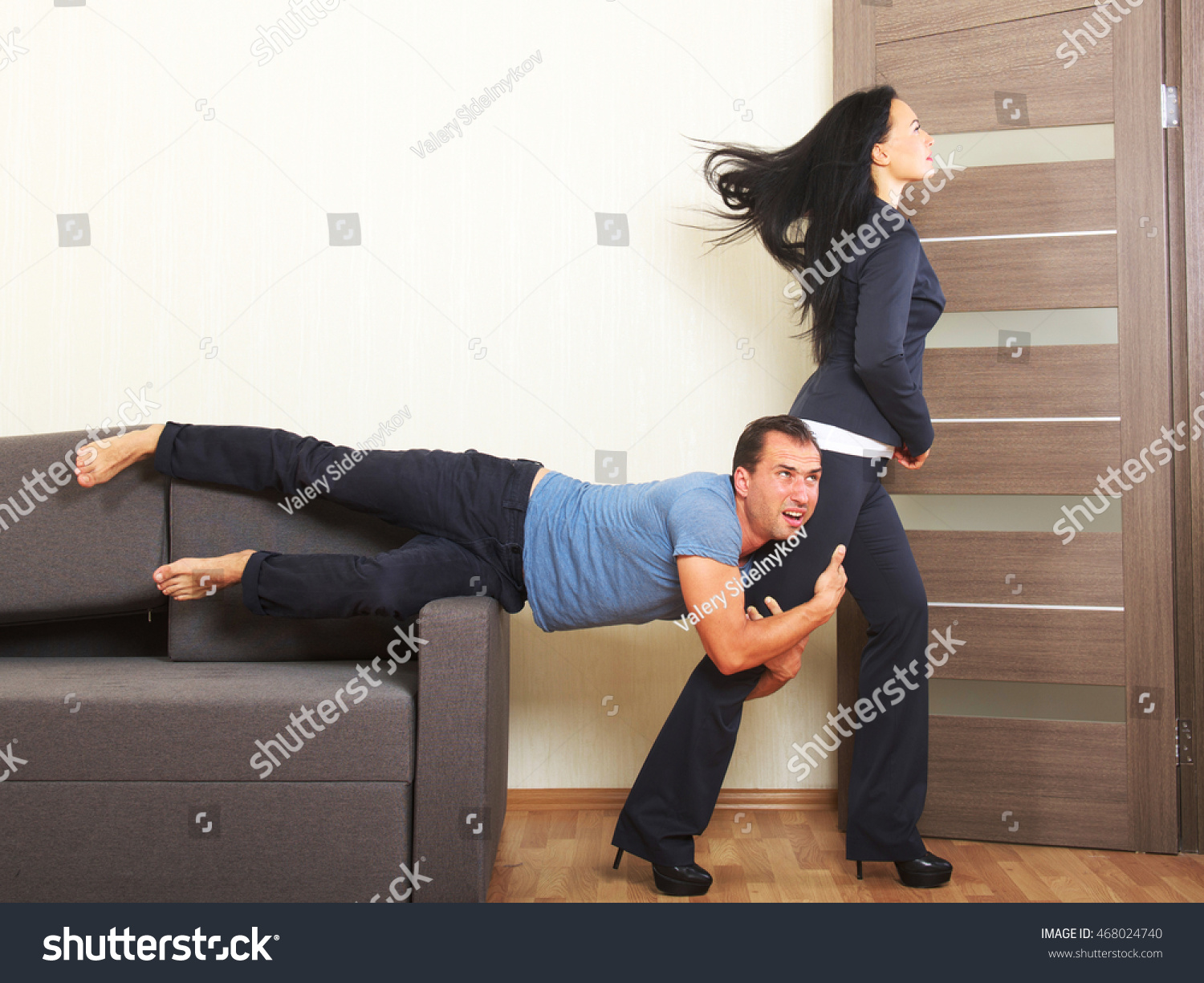 Man desperately clinging to the leg of a woman #468024740