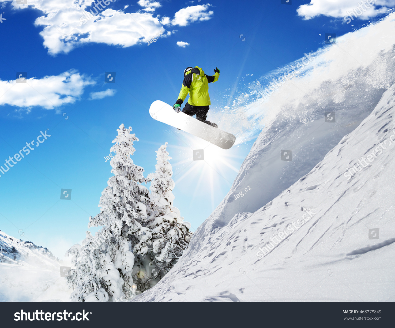 Snowboarder at jump in Alpine mountains in beautiful sunny day. Copy-space for text #468278849