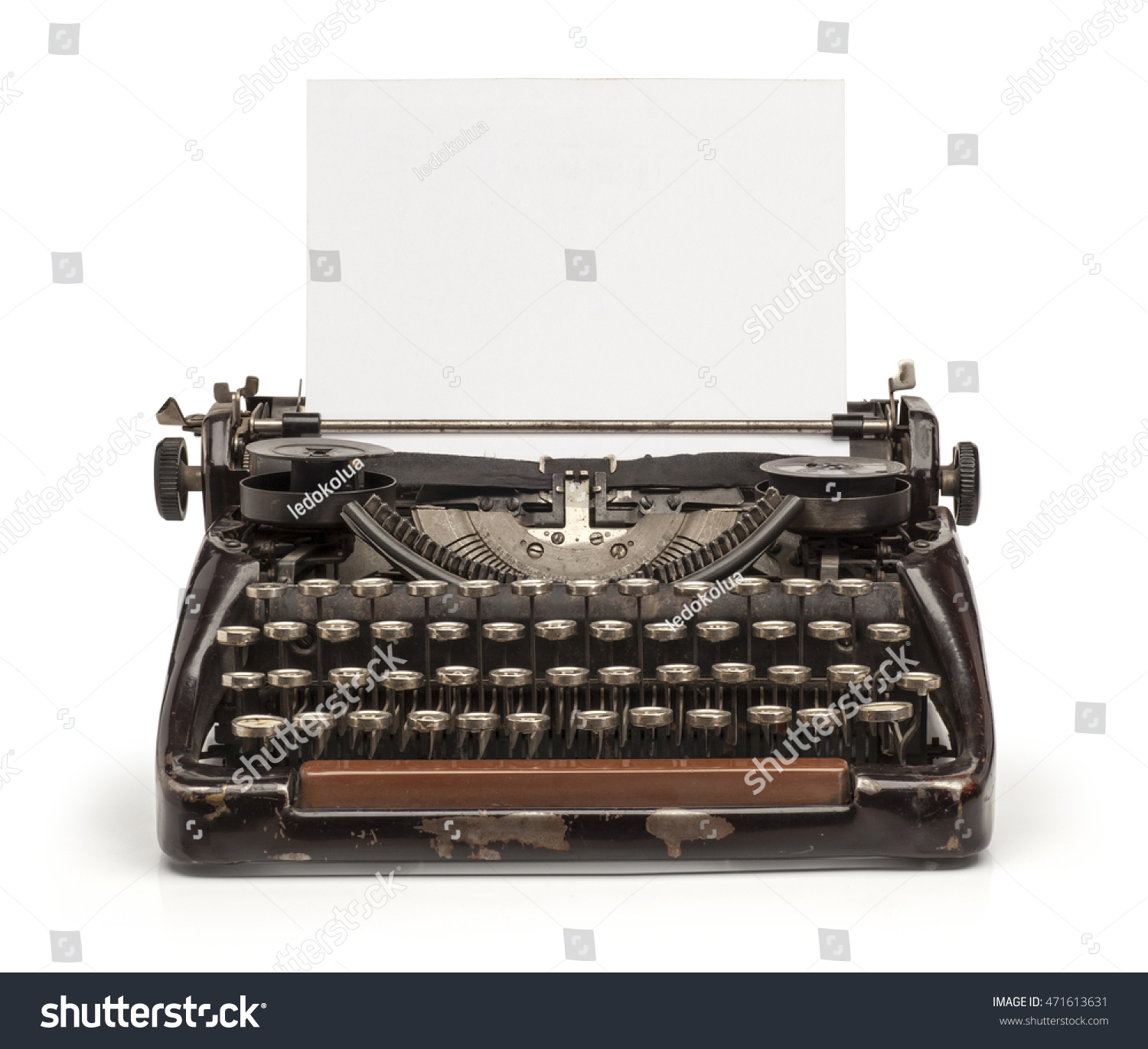 Old vintage typewriter and a blank sheet of paper inserted. Isolated on white background.

 #471613631