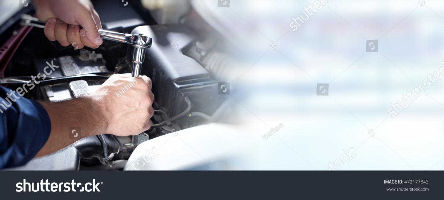 Hands of car mechanic in auto repair service. #472177843