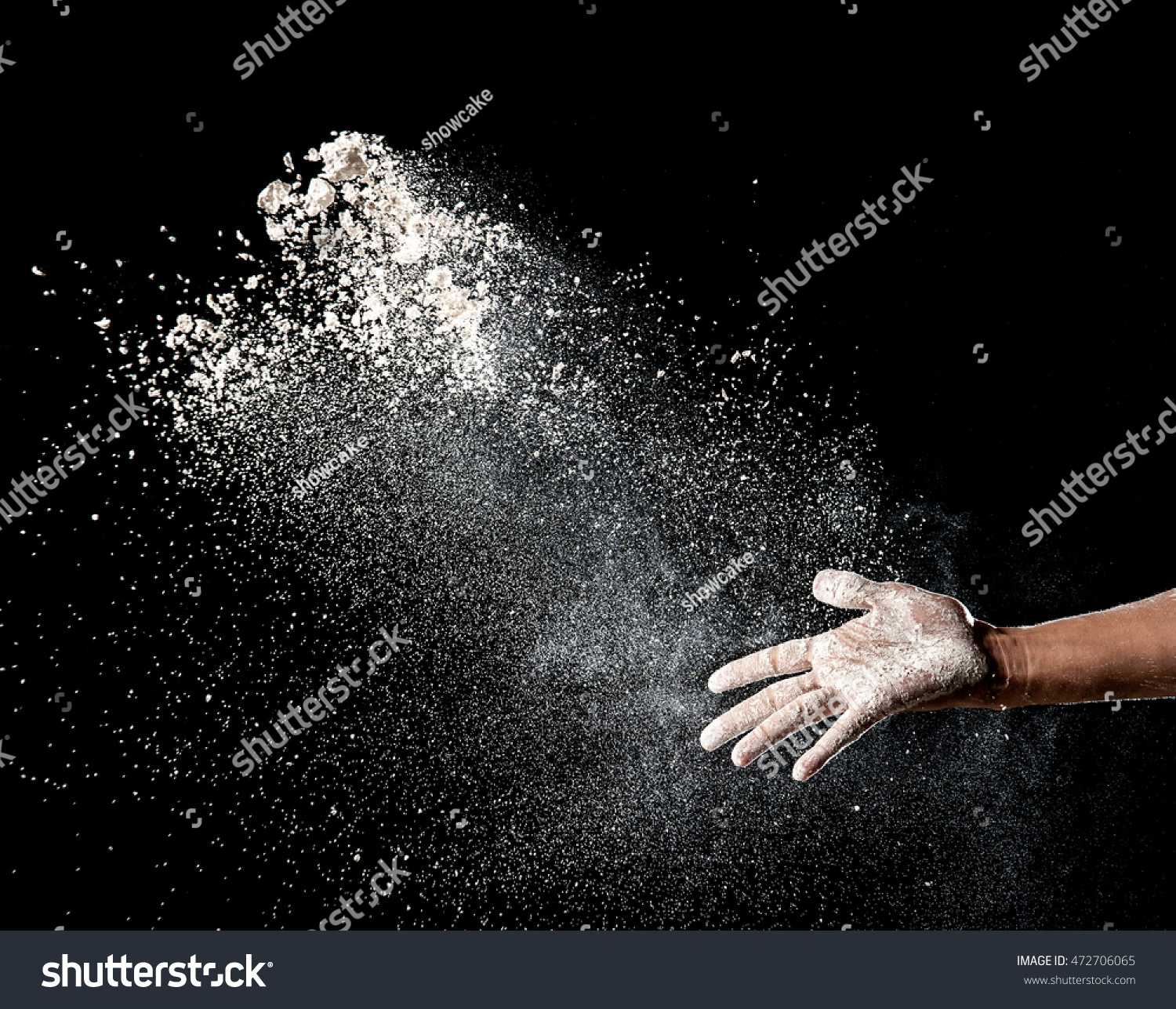 Hand and flour on black background #472706065