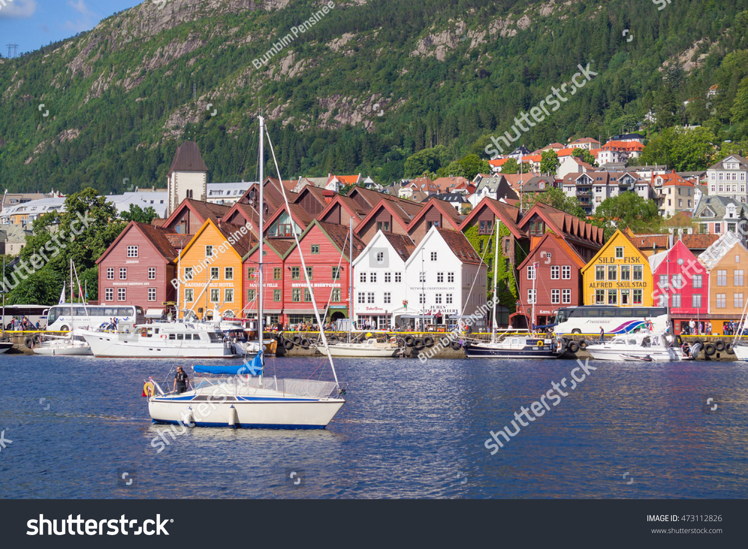 Bergen,Norway - July 20, 2016 : View of Bryggen, a series of Hanseatic commercial buildings lining the eastern side of the fjord coming into Bergen, Norway #473112826