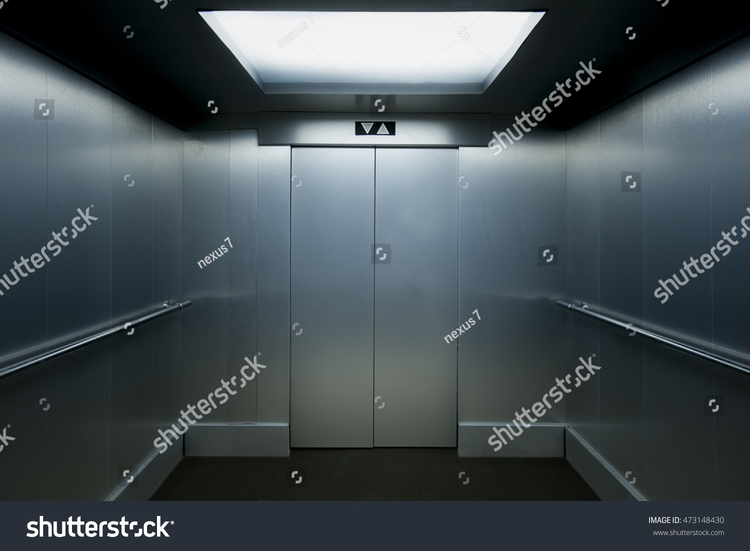 Interior view of a modern elevator with metallic walls. #473148430