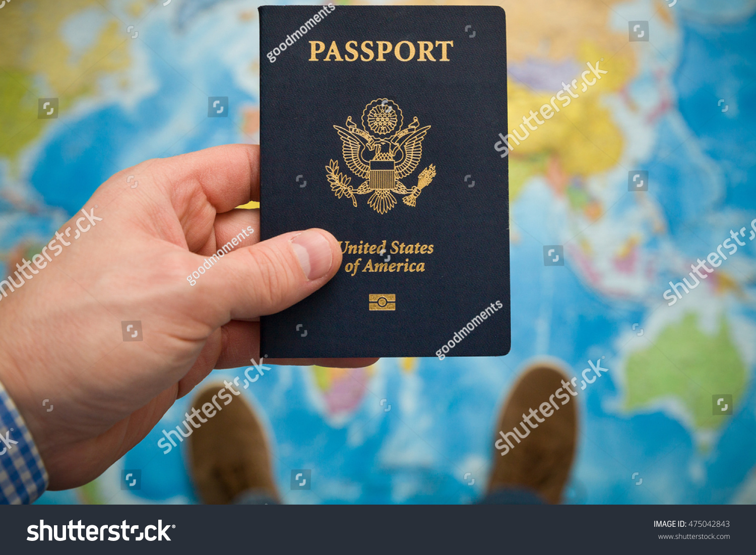 Man's hand holding US passport. Map background. Ready for traveling. Open world. #475042843