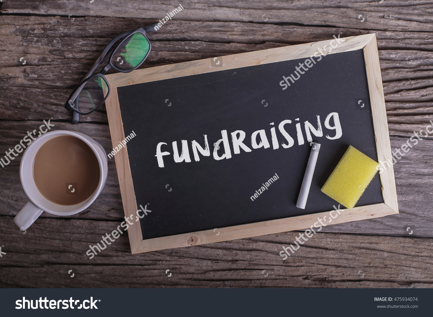 Fundraising On blackboard with cup of coffee, with glasses on wooden background #475934074