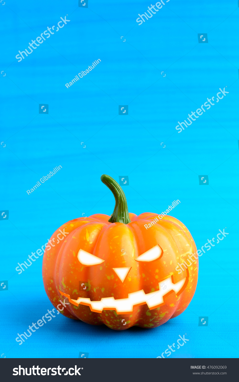 Three Halloween pumpkin with scary face on a blue background #476092069