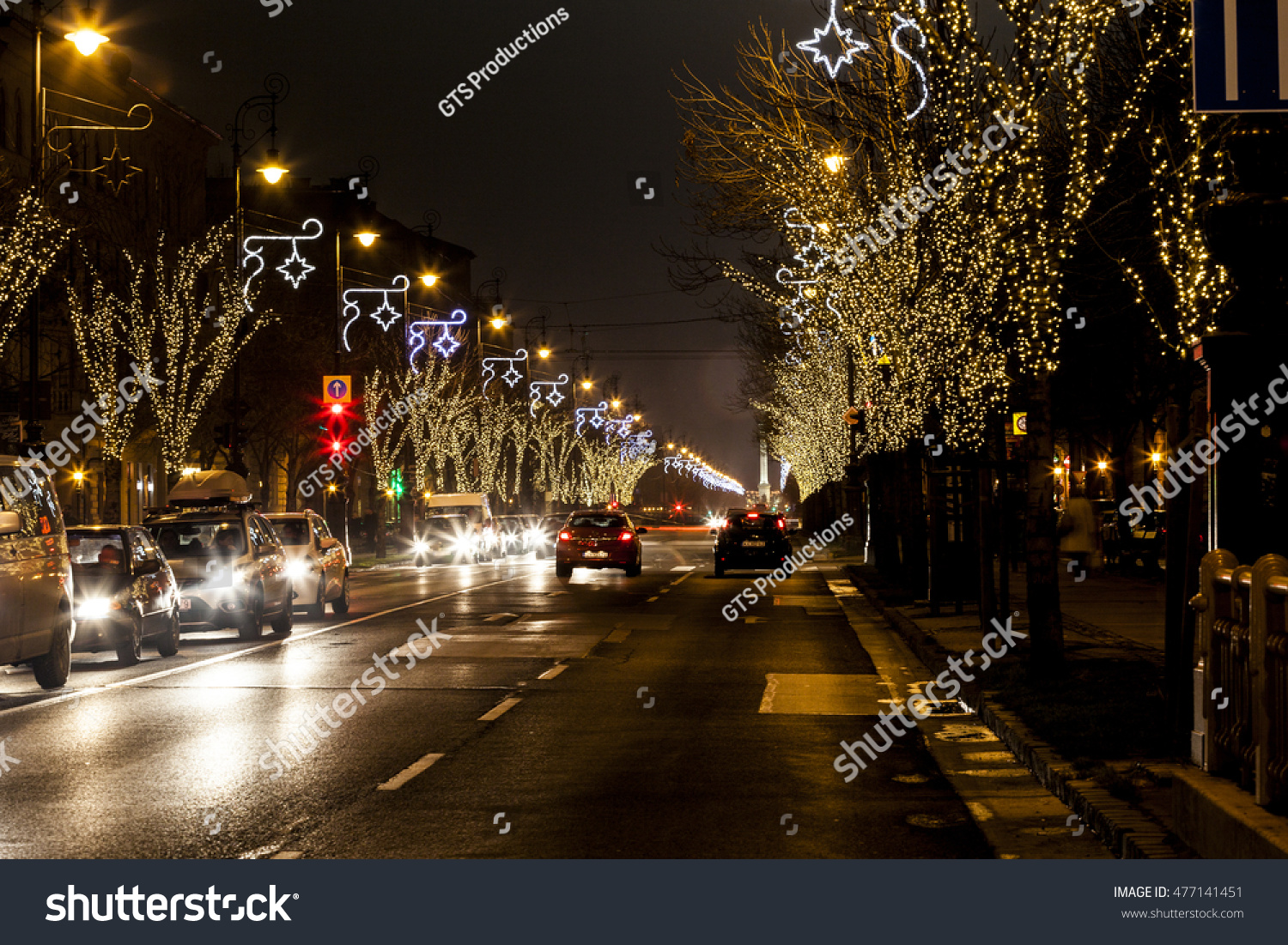 BUDAPEST, HUNGARY - DEC 19 2015: Tourists enjoy the Christmas spirit and the light show in down town Budapest. This traditional Christmas fair attracts over million visitors each year. #477141451