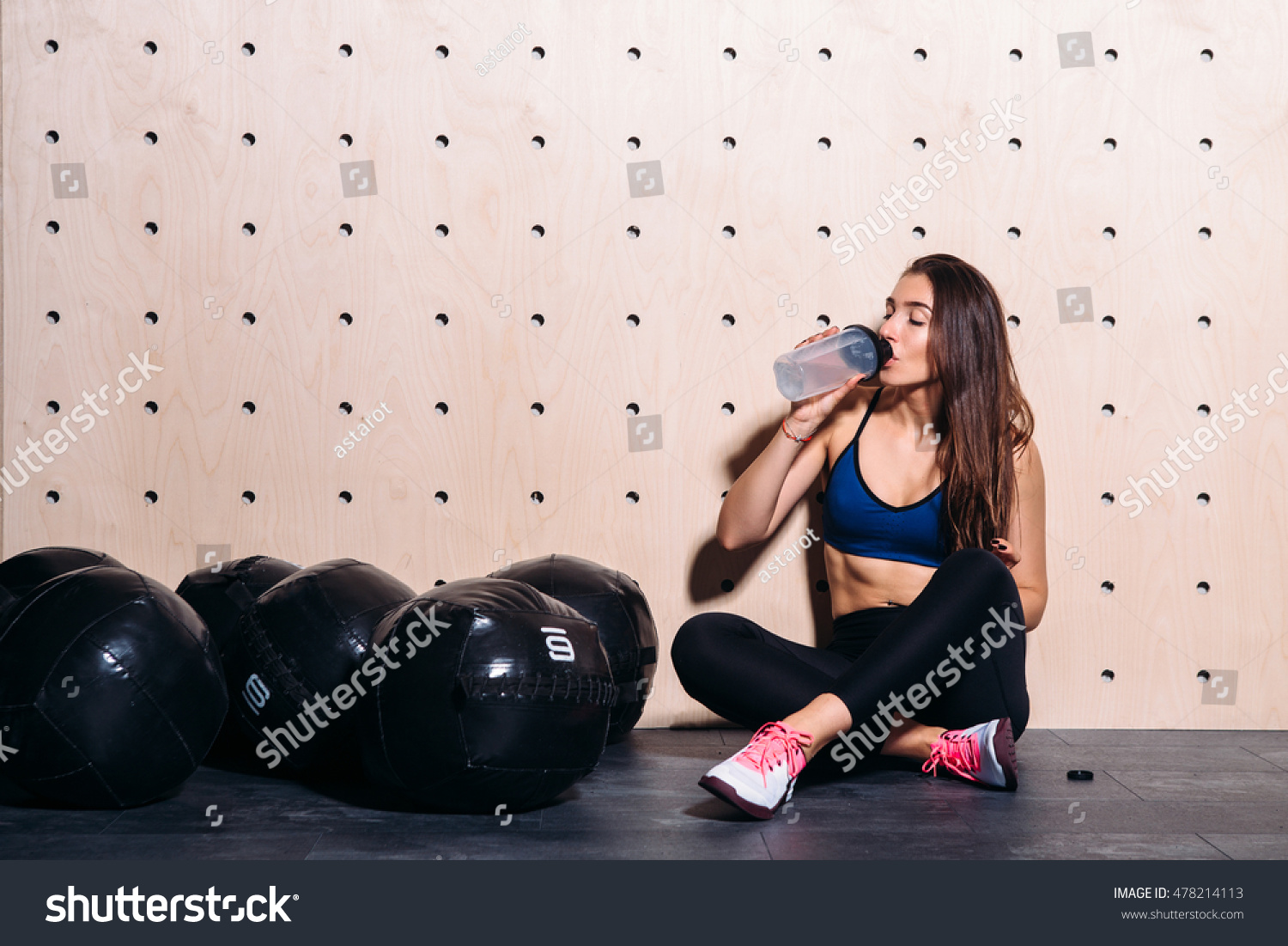 Girl drinking water at the gym #478214113