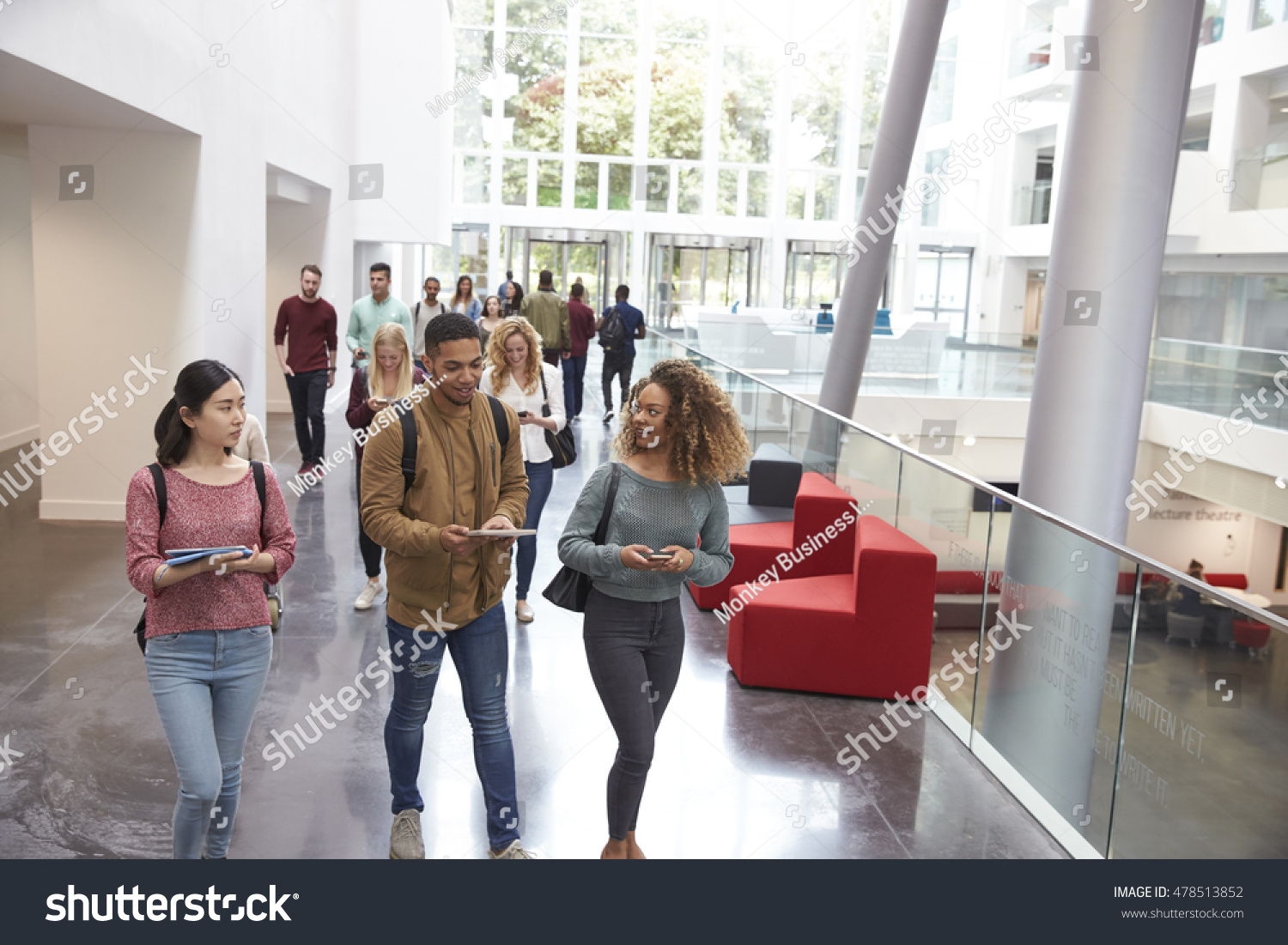 Students walk and talk using mobile devices in university #478513852