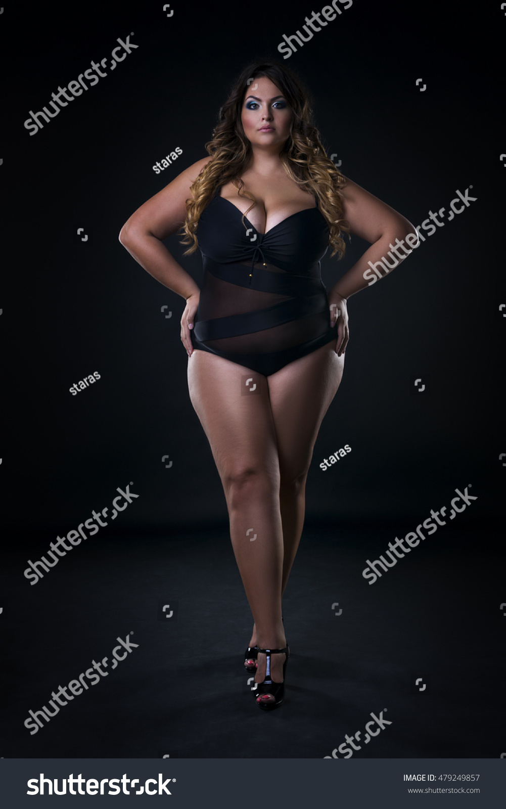 Curvy busty plus size model in push up bra on gray background, overweight  w.. Stock Photo #247827490