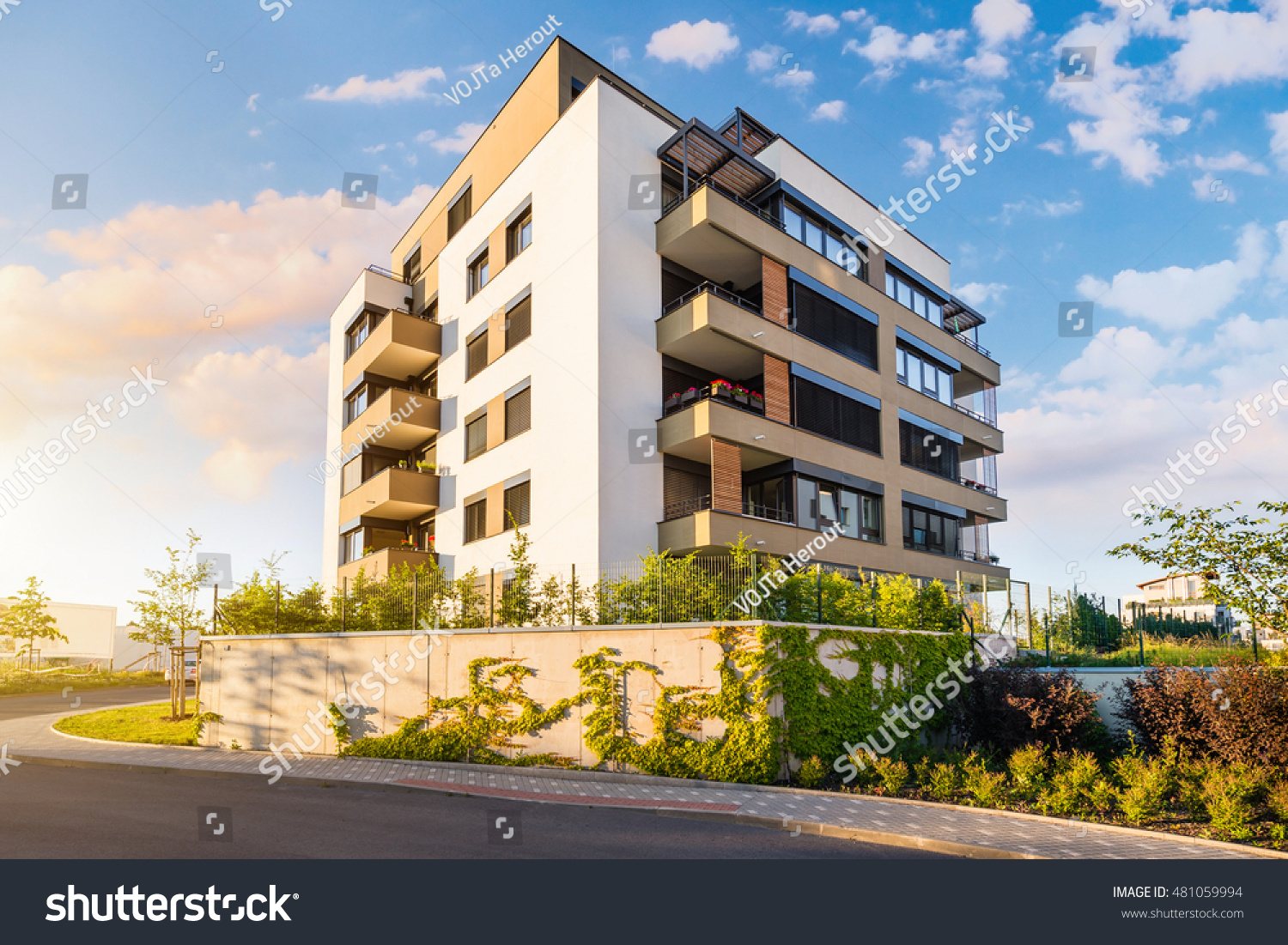 New modern block of flats in green area with blue sky #481059994