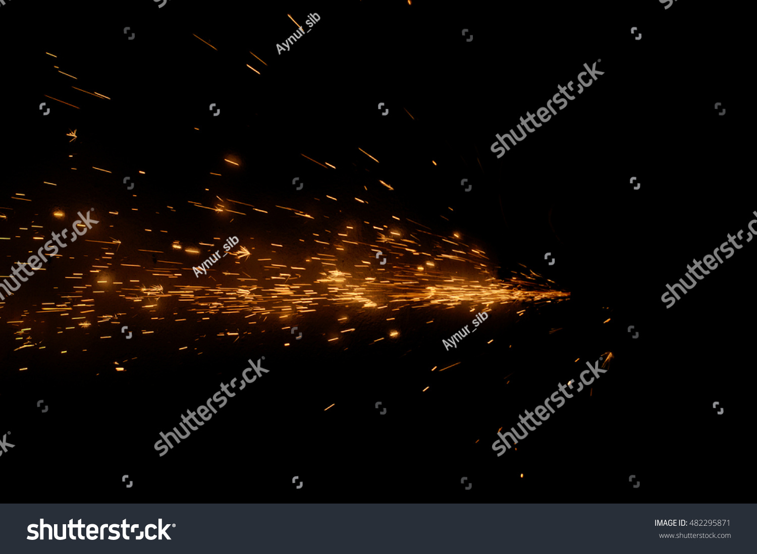 Fire sparks on a black background during metal cutting, hot burning element in flame  #482295871