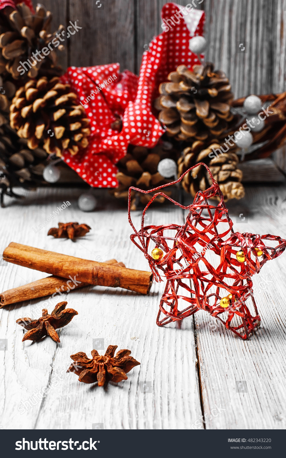 Christmas decoration on the background of the Christmas wreath with pine cones #482343220