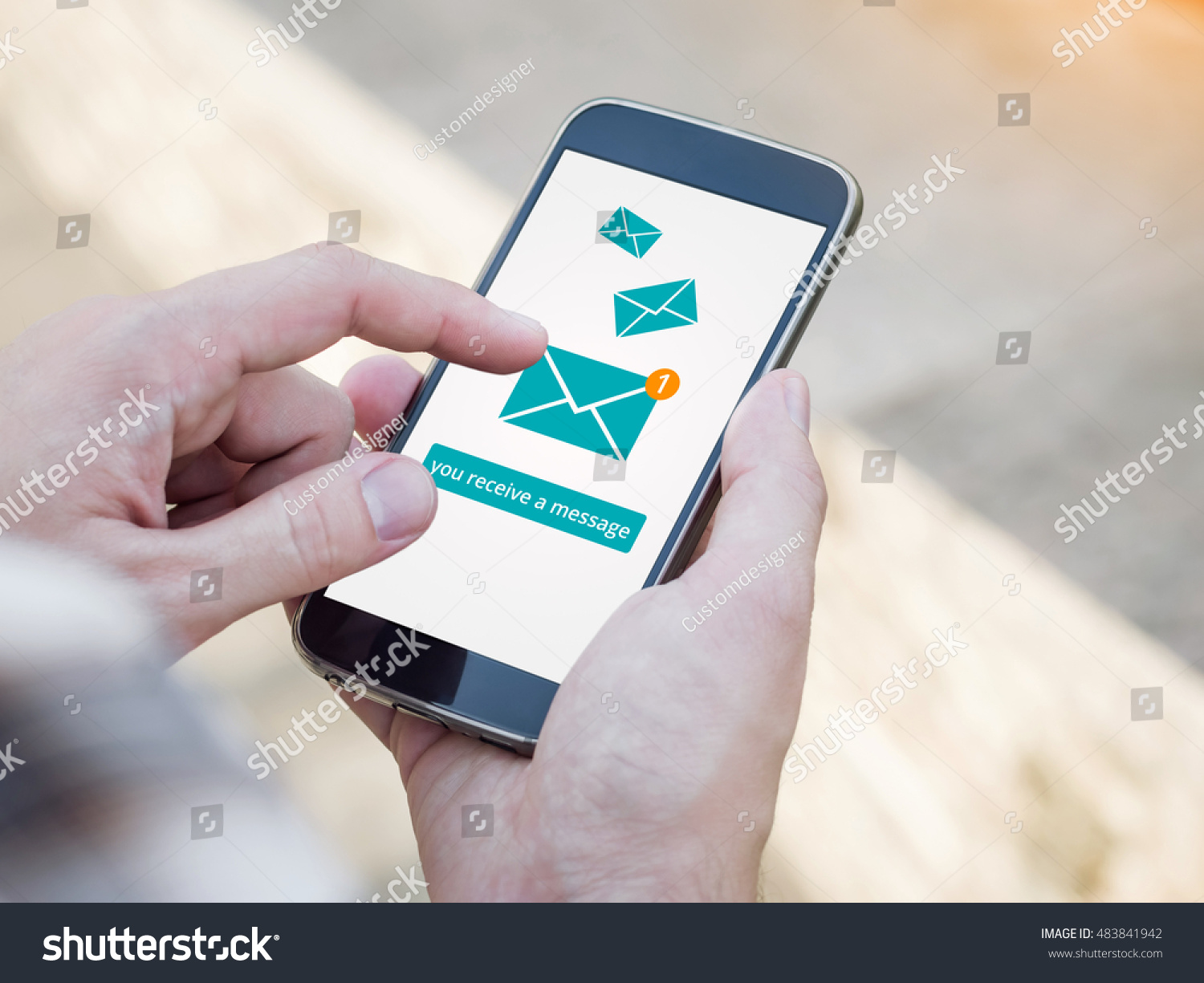 Email app on smartphone screen. You receive a message, New message is received. Man's Hand holding a smartphone #483841942