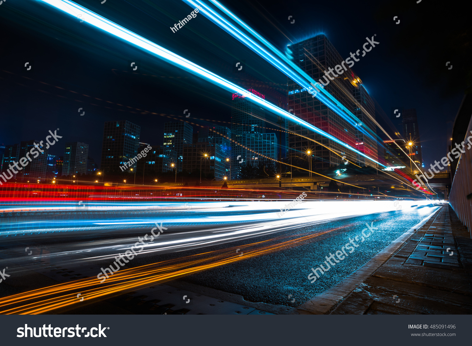 blurred traffic light trails on road at night in China. #485091496