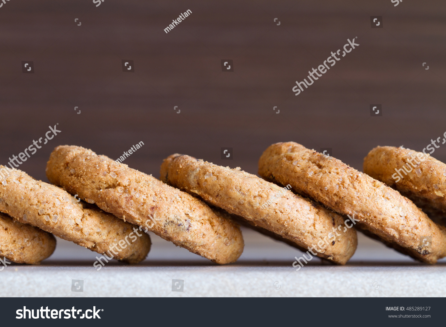 Several chocolate chip cookies on dark background. Close-up #485289127