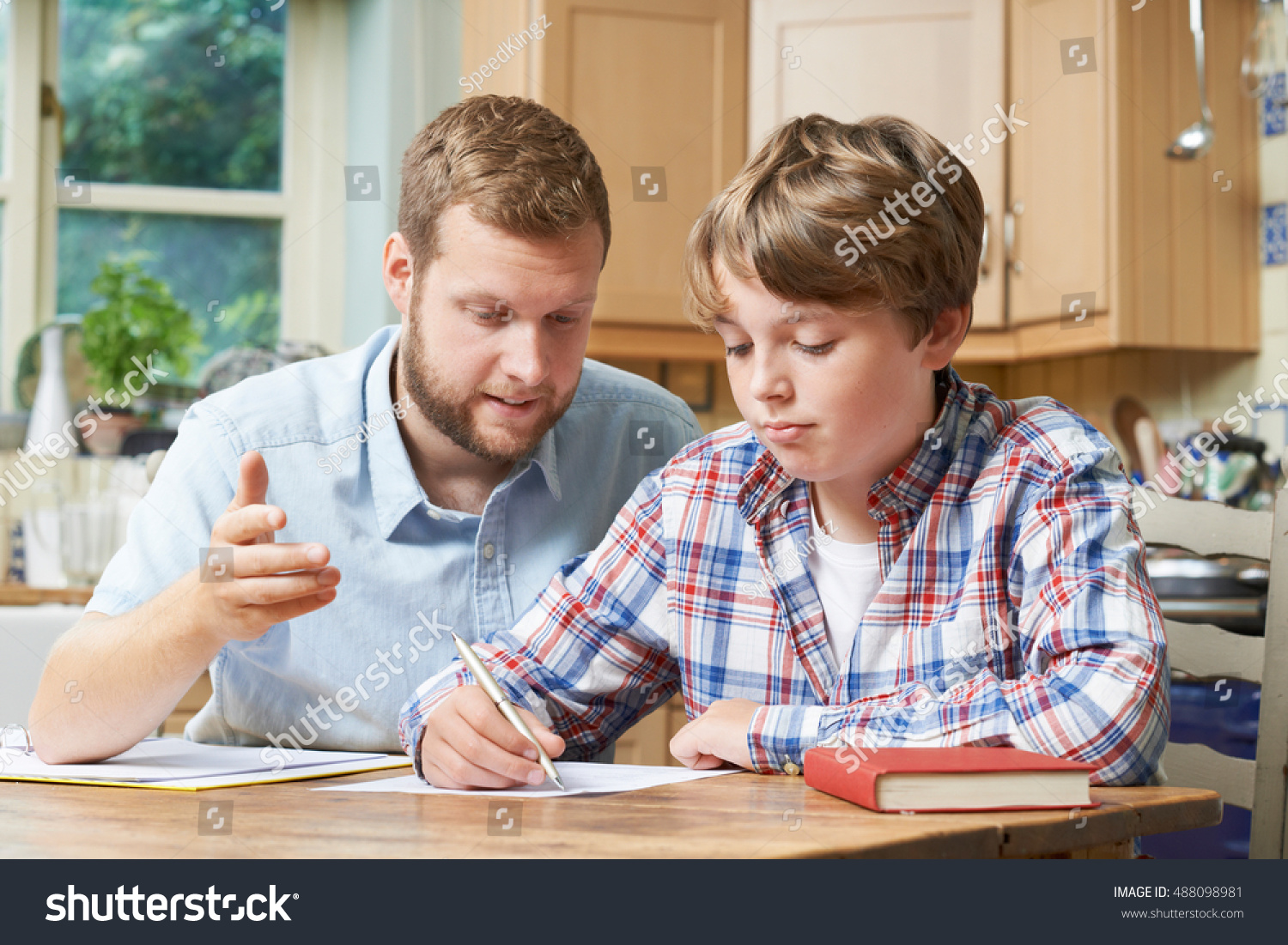Male Home Tutor Helping Boy With Studies #488098981