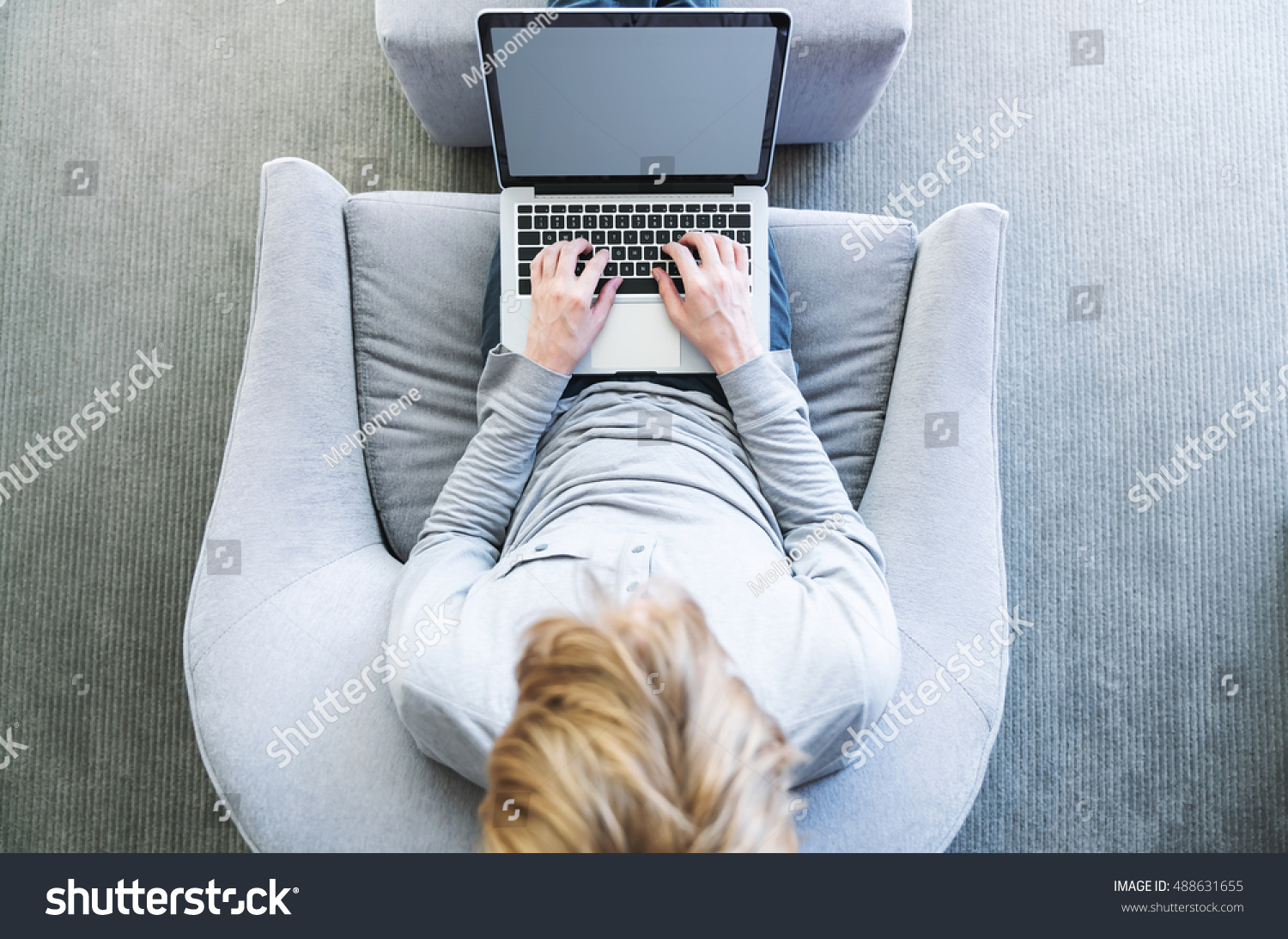 Top down view of young blond person typing on laptop computer #488631655
