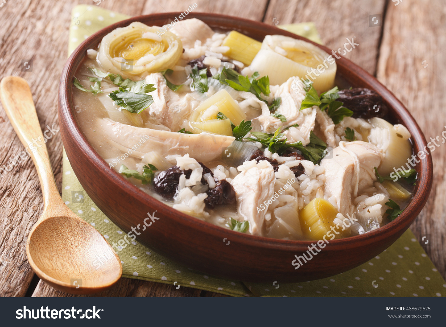 Scottish cock-a-leekie soup with leeks and prunes close up in a bowl on the table. horizontal
 #488679625