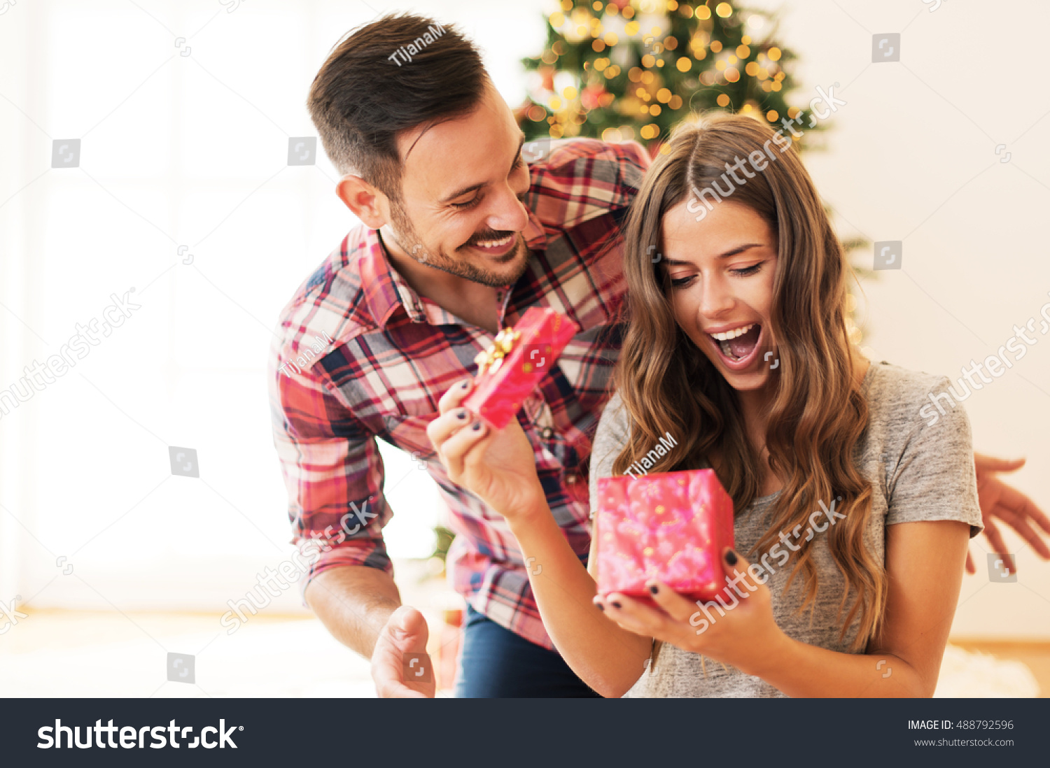 Man giving a Christmas present to his girlfriend #488792596