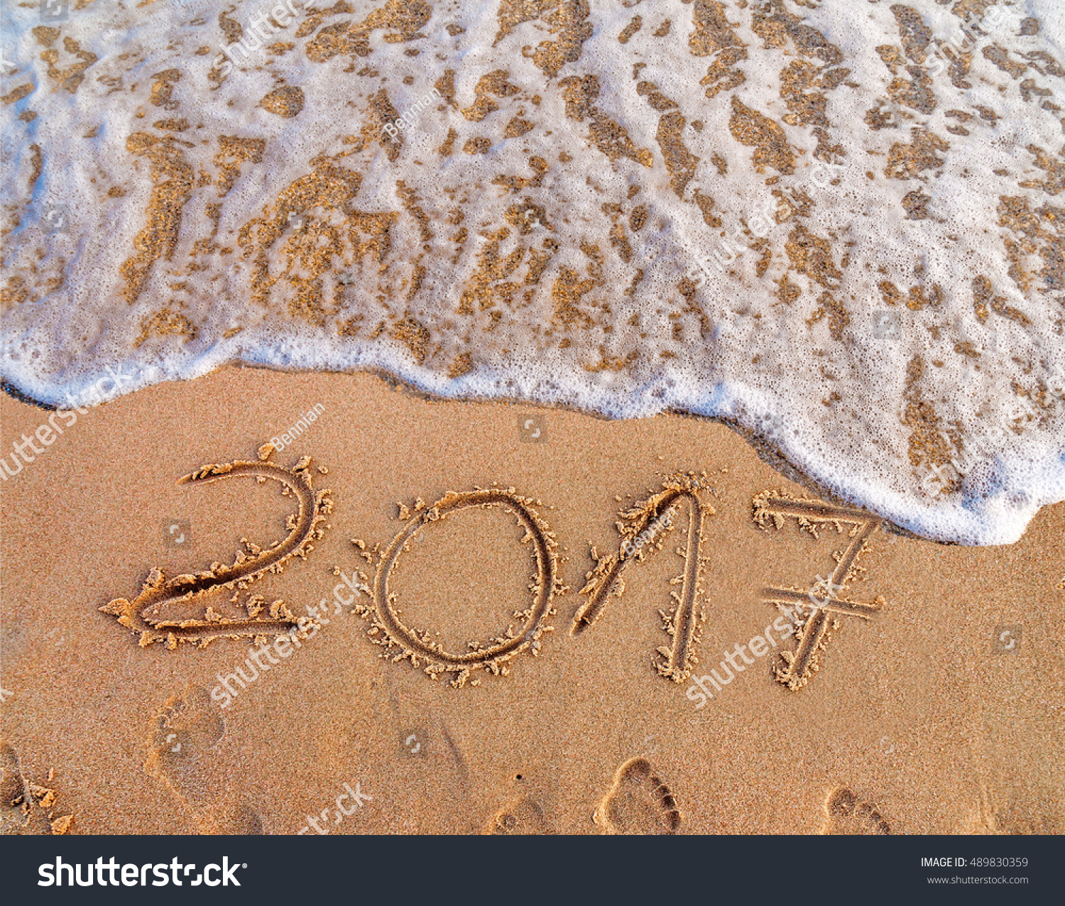 New Year 2017 is coming concept written on sandy beach  #489830359