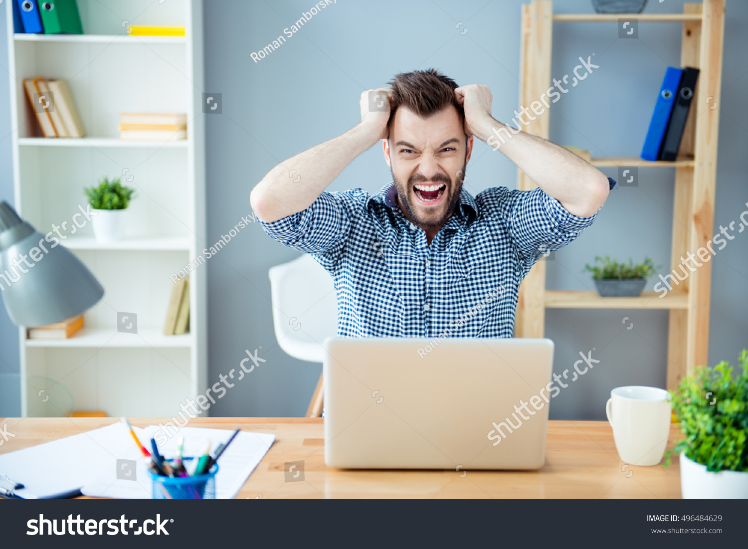 Frustrated  tired man  with laptop having a lot of work and screaming #496484629