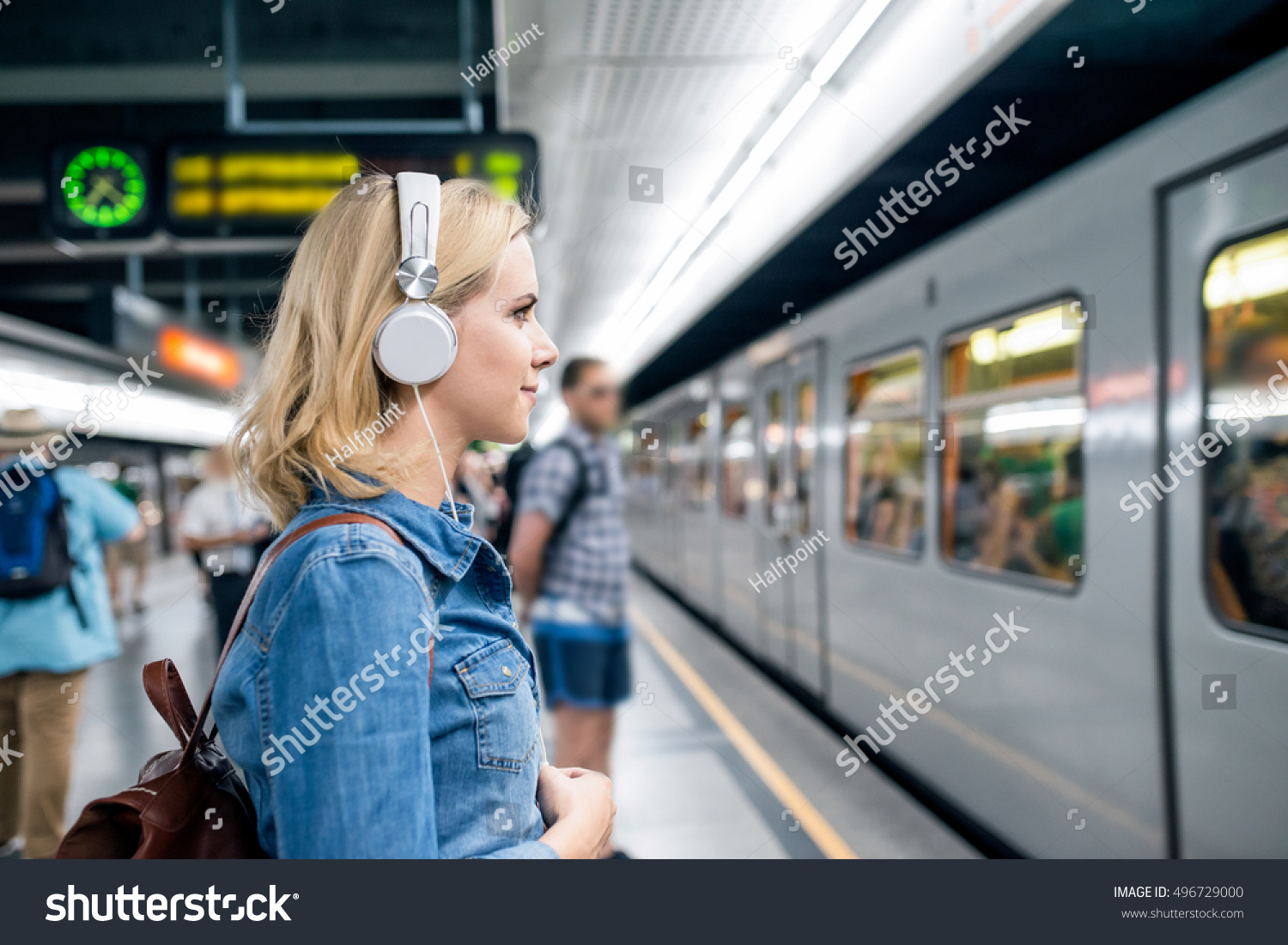Young woman in denim shirt at the underground platform, waiting #496729000