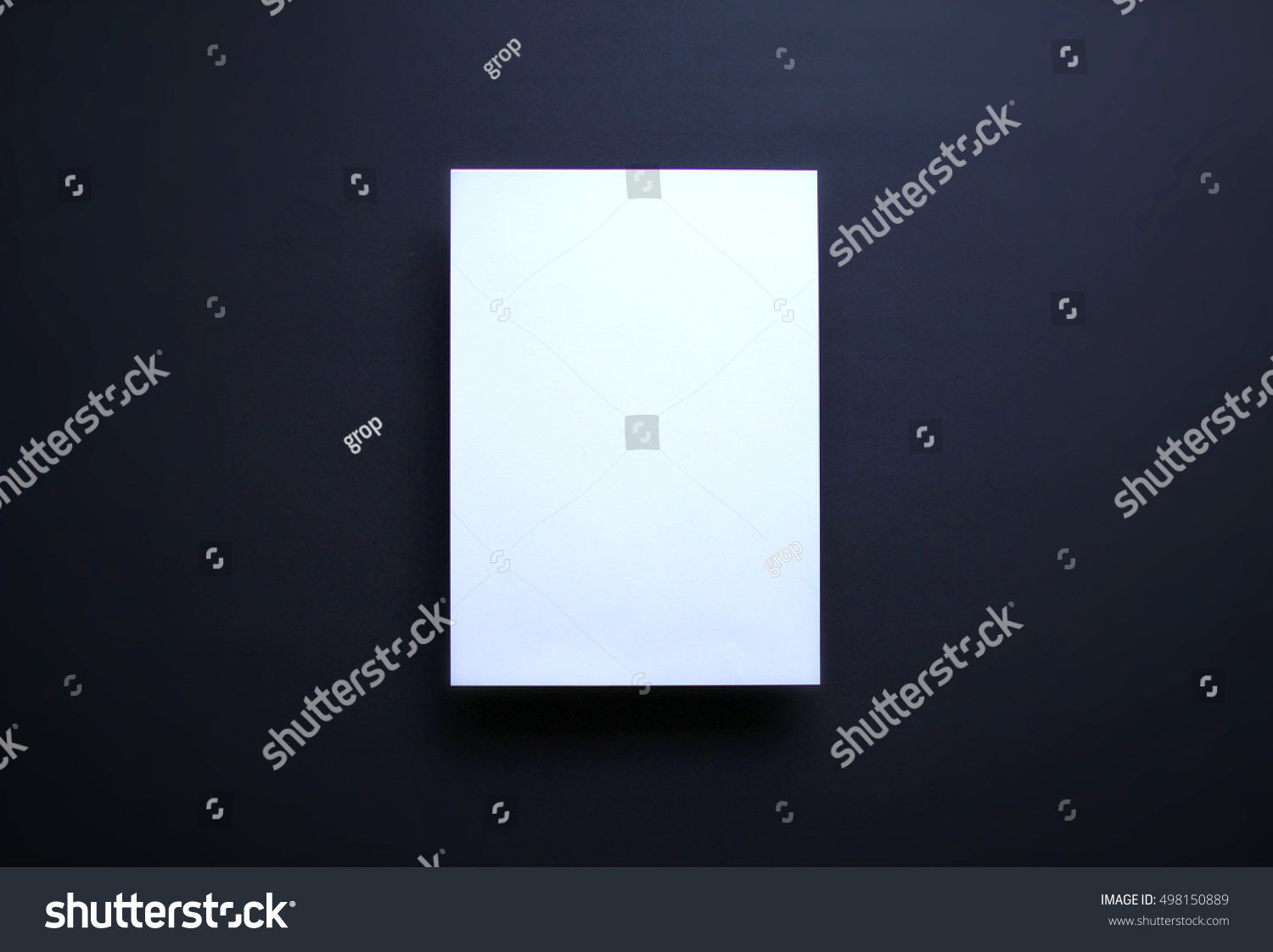 Empty white paper sheet isolated on dark blue background #498150889