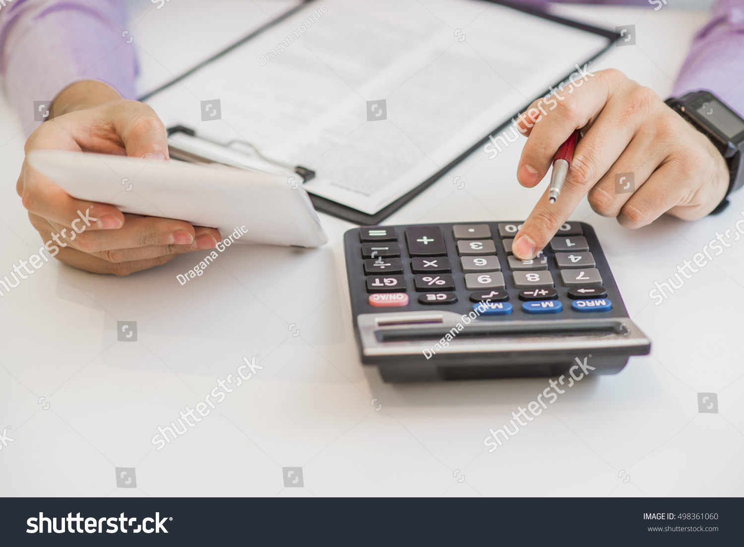 Close up of male accountant or banker making calculations. Savings, finances and economy concept #498361060