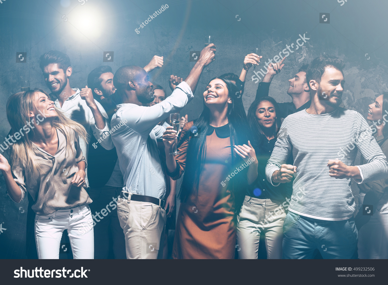 Unstoppable party. Group of beautiful young people dancing together and looking happy #499232506