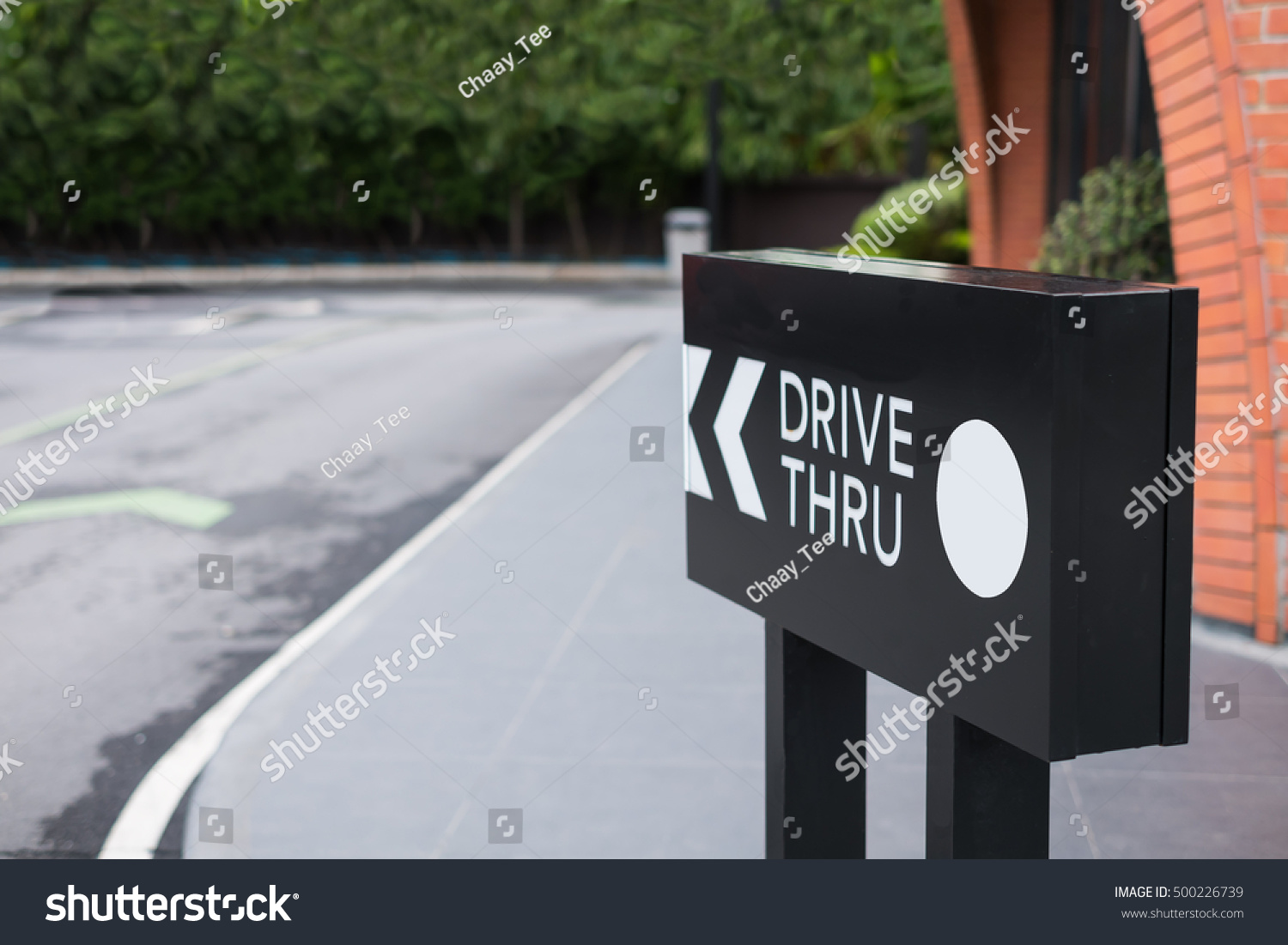 Drive thru sign with shop and road background. #500226739