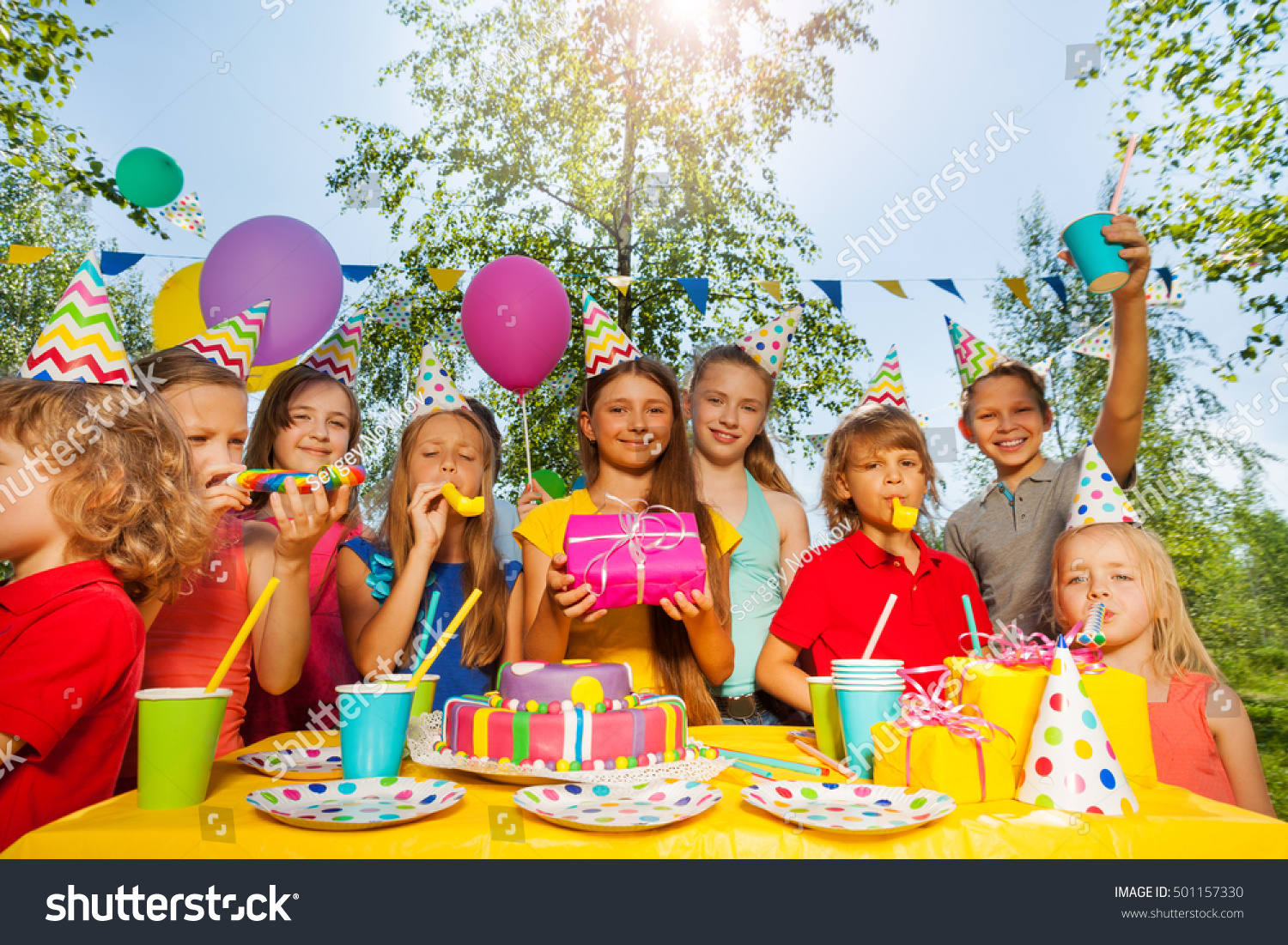 Funny kids cheering birthday girl at summer park #501157330