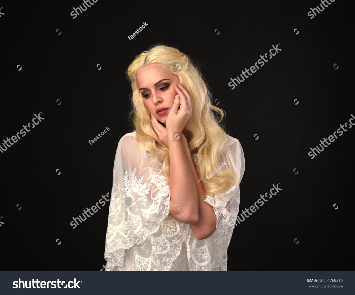 portrait of a beautiful woman with long blonde hair, wearing a white lace dress. isolated on a black background. #501769216