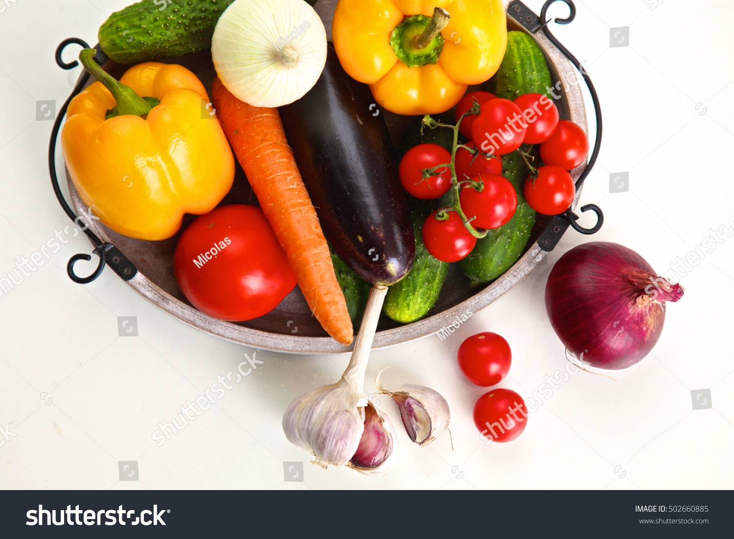Pile of organic vegetables on a rustic wooden table #502660885