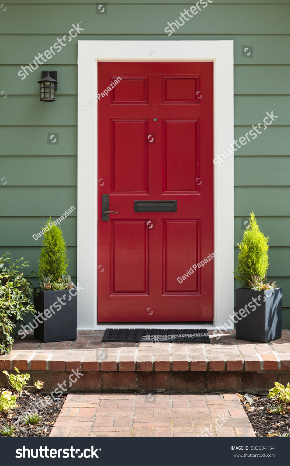 Front view of a bright red front door. #503634154