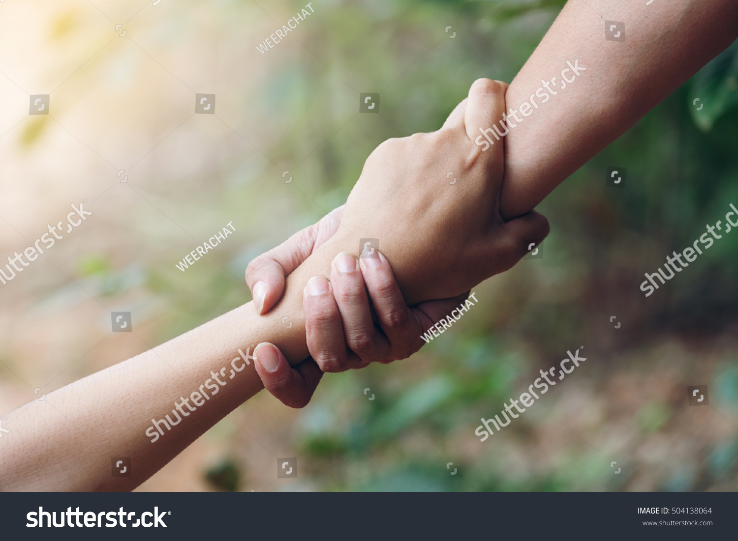 Teamwork respect relationship rescue two buddy Friends trust helping holding hands pulled Help grip each other agreement contract together #504138064