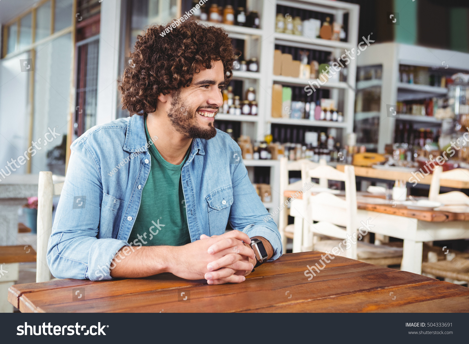 Man sitting and smiling in cafeteria #504333691