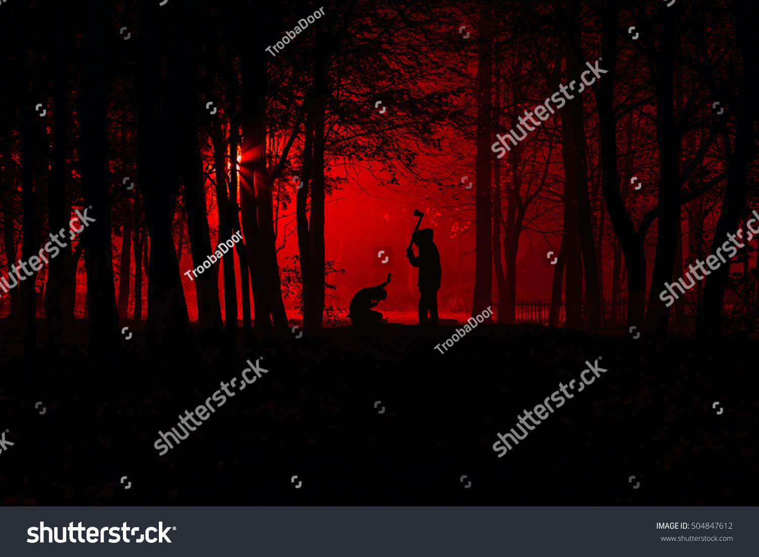 Maniac swings ax on his prey. Murder in the park. Maniac kills his victim in the night deserted park. Silhouettes in night foggy forest #504847612