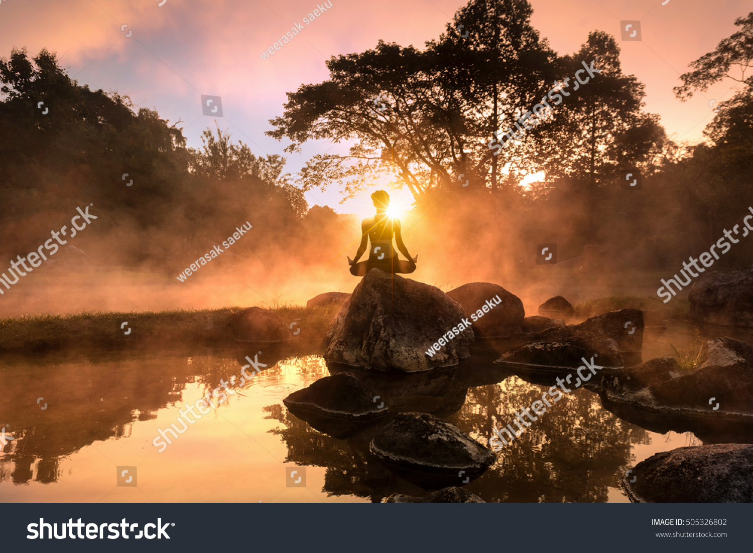 Young woman meditating by the lake #505326802