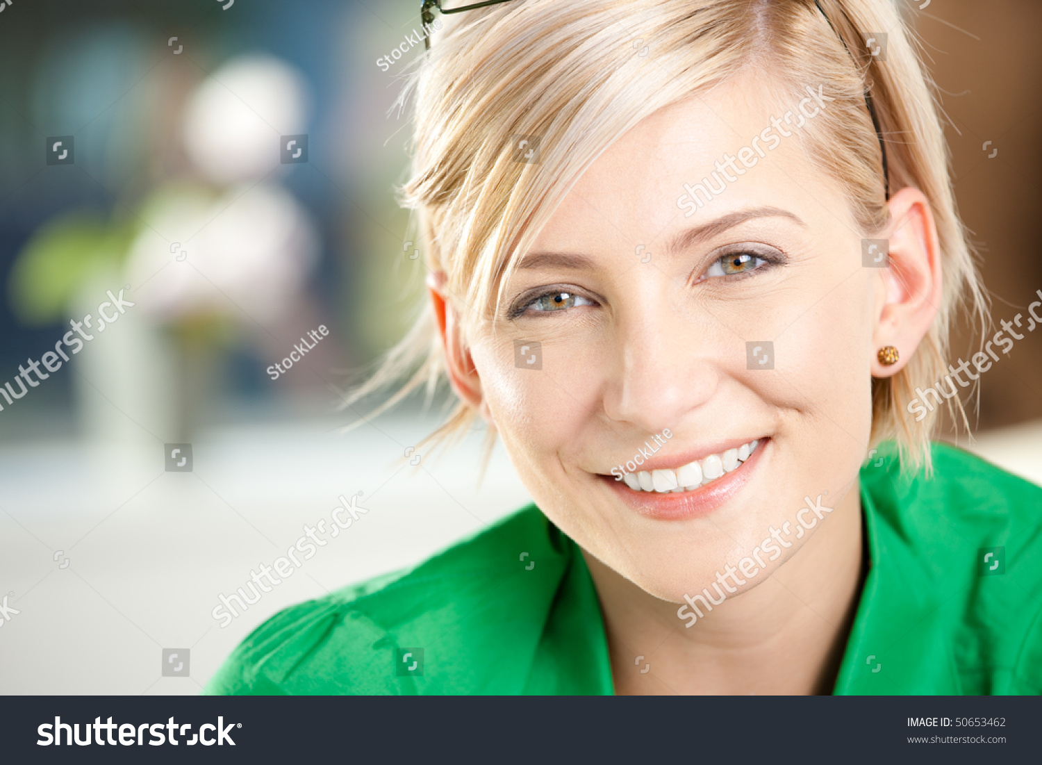 Closeup portrait of happy young businesswoman wearing green shirt, smiling. #50653462