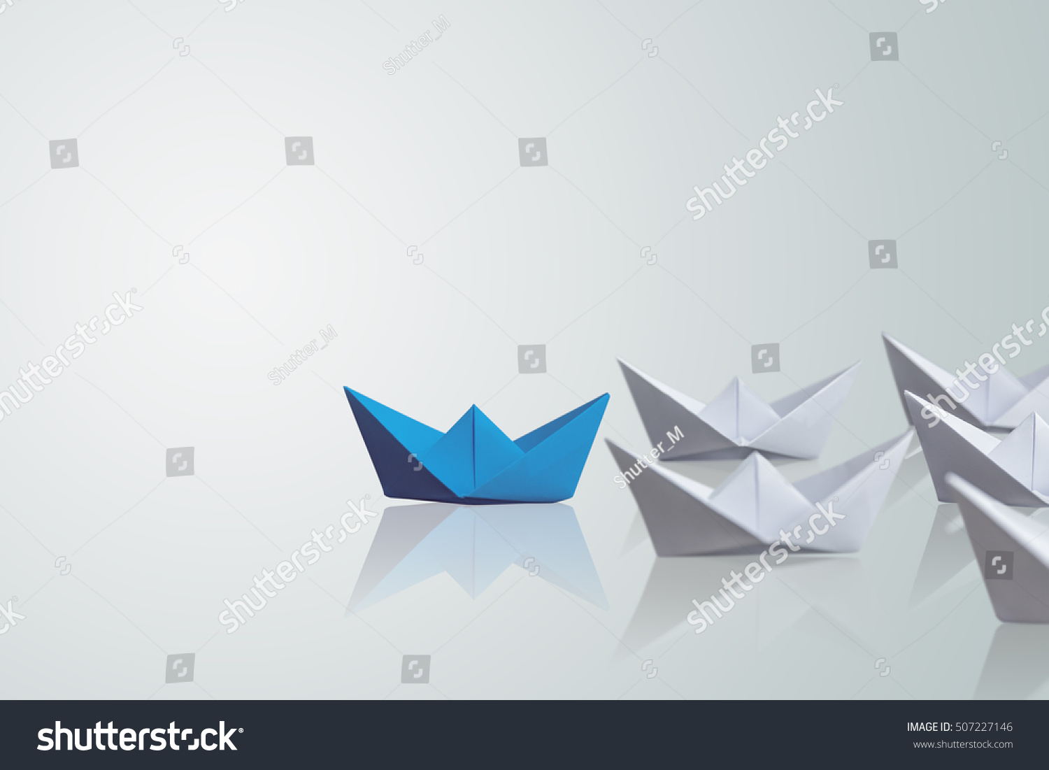 uniqueness concept, paper boat outstanding from the others  #507227146