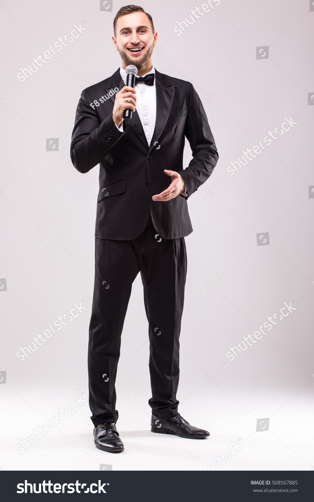 Young Showman presenter with microphone against white background.Showman concept. #508507885
