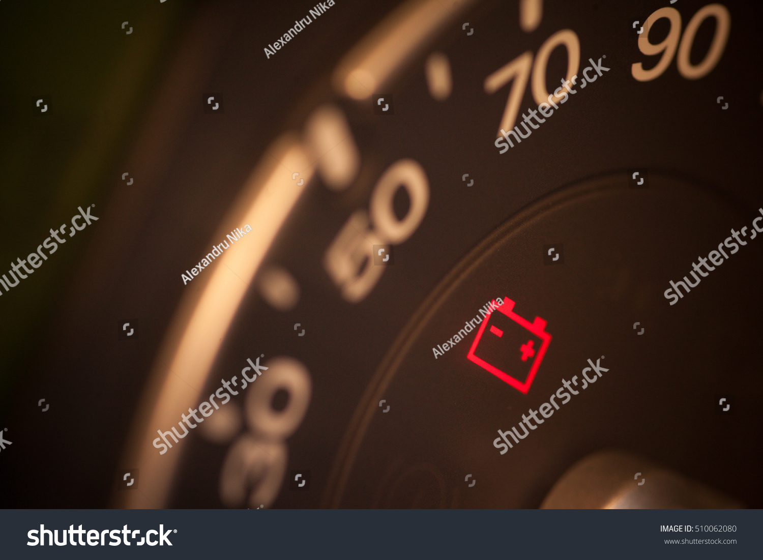 Close up shot of a car's dashboard with the battery icon lit. #510062080
