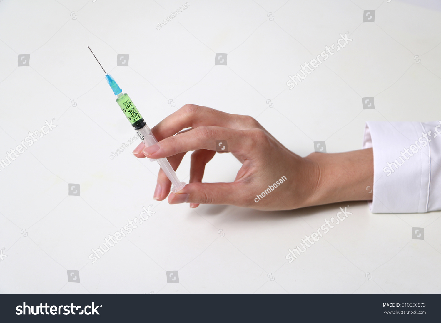 injector held by woman hand #510556573