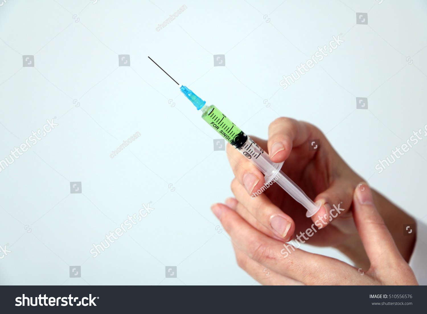 injector held by woman hand #510556576